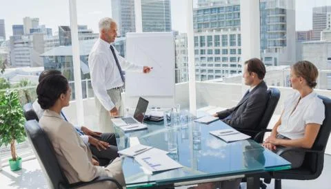 Manager pointing at a chart during a meeting Stock Photos