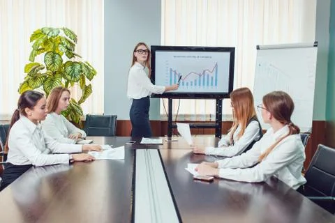 Manager presenting business activity plan to his colleagues Stock Photos