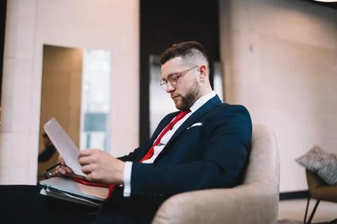 Manager reading documents in office lounge Stock Photos