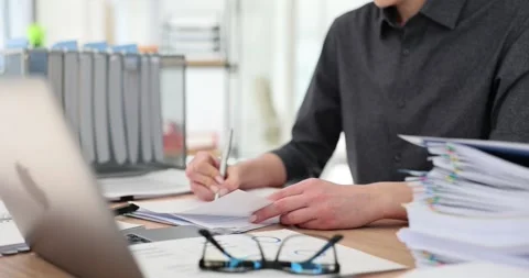 Manager reads financial documents with statistics makes corrections and compares Stock Footage 240413012