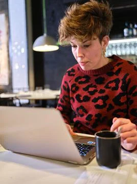 Manager of a restaurant working with a laptop inside the business Stock Photos