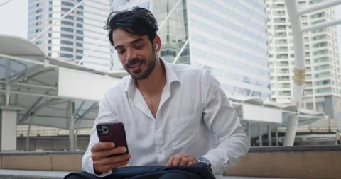 Manager with satisfied expression types message phone during work break Stock Footage 312500420