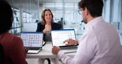 Manager schedules team events using online calendar during virtual meeting Stockfoto's