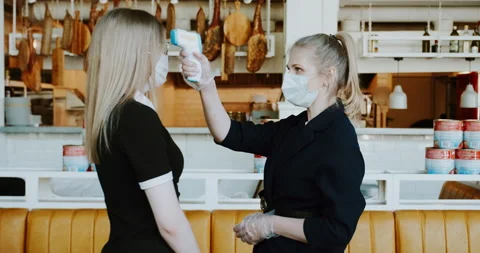 Manager screening temperature of waiter, worker of restaurant, for safety. Stock Footage 130548260