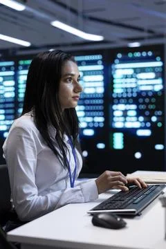 Manager in server hub using computer to find firewall misconfigurations Stock Photos