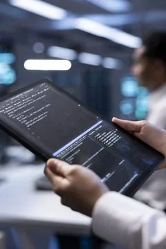 Manager in server hub using tablet to find firewall misconfigurations 写真素材