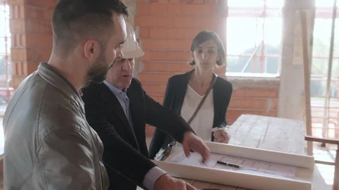 Manager Showing Project Plan To Married Couple In New Home Stock Footage 98800323