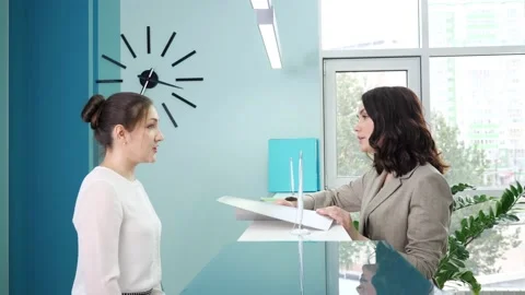 Manager shows registration book to client at reception Stock Footage 153889902