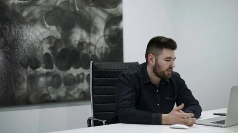 Manager sits at the desk in the office and sets out thoughts Stock Footage 82130253