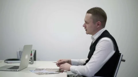 Manager sits at the table and speak Stock Footage 82130721