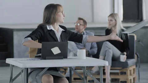 The manager sits at the table and takes documents from a colleague. In the Stock Footage 124664295