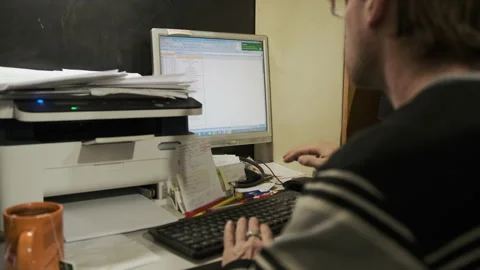 The manager sits at the workplace at the computer and fills out a spreadsheet Stock Footage 149606927
