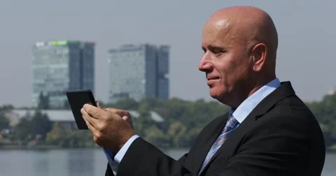 Manager Smiling While Communicating Using Touch Tablet with His Business Partner Stock-Footage 68439402