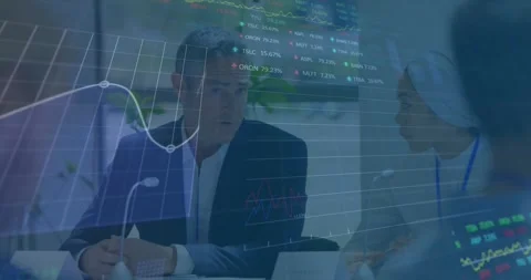 Manager speaking into mic at table, financial overlay fading in and showing Stock Footage 334835609