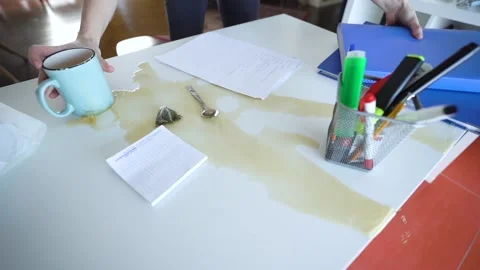 Manager Spilling Tea On The Work Desk  Jumping up to Save Important Documents Stock Footage 148126884