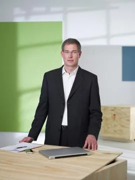 Manager standing in loft office Stock Photos