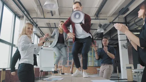 Manager start to dance on the table, sings into a megaphone. Managers enjoy Stock Footage 108379158