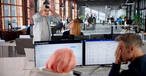 Manager Struggles With Team To Solve Critical Financial Crisis At Work. Stock Photos