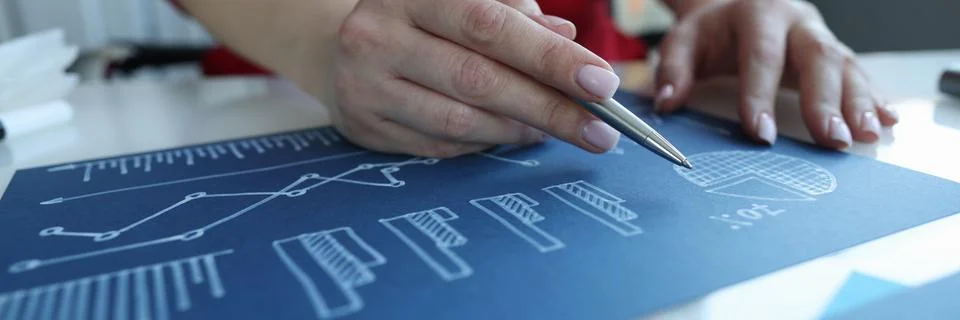 Manager studying documents with statistical graphs on blue paper closeup Stock Photos