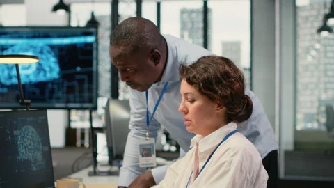 Manager supervises intern in startup office using artificial intelligence Stock Footage 323143713
