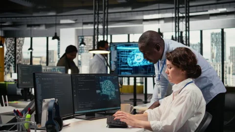 Manager supervises intern in startup office using artificial intelligence Stock Footage 323143830