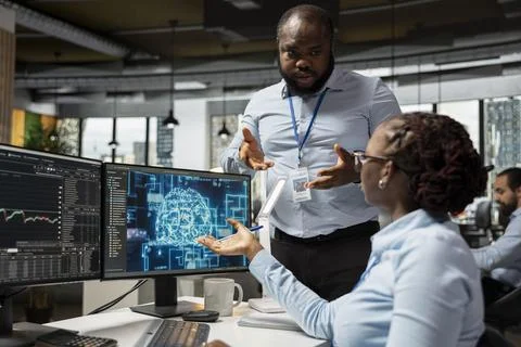 Manager supervises work of financial expert in office using large language model Stock Photos