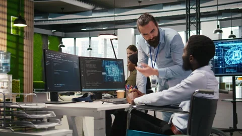 Manager supervising developer with paraplegia writing deep learning code Video stock 313016658
