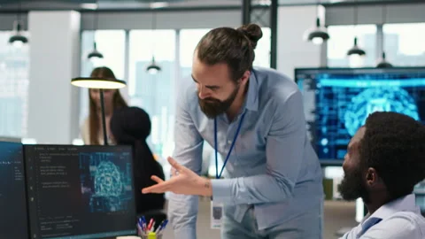 Manager supervising developer with paraplegia writing deep learning code Stock Footage 313165644