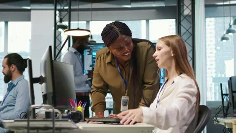Manager supervising young trainee in office using AI technology Stock Footage 313168055