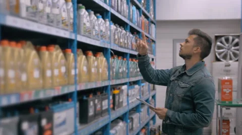 Manager With Tablet PC Checking Goods At Car Supermarket Warehouse shop Stock Footage 67569886