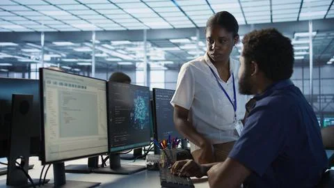 Manager taking feedback from data center engineer Stock Photos