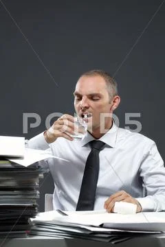 Manager taking medicine at workplace Stock Photos