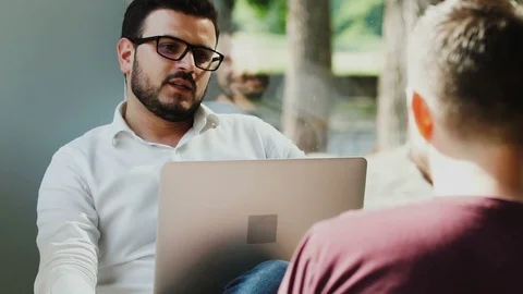 Manager talking with candidate at job interview in the cafe with laptop Stock Footage 112991166