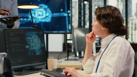 Manager talking with engineer in office automating workflows using AI Stock Footage 322703654