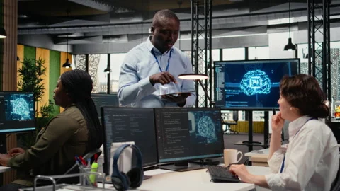 Manager talking with engineer in office automating workflows using AI Stock Footage 322705228