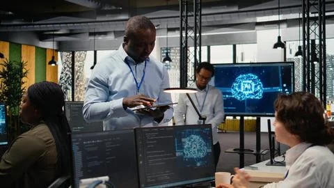 Manager talking with engineer in office automating workflows using AI Stock Photos
