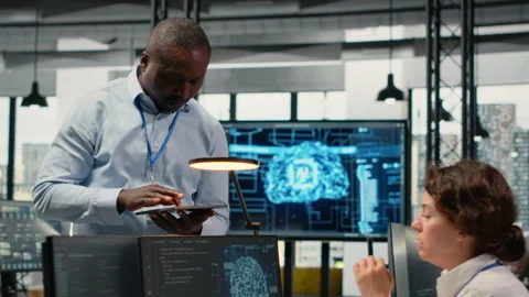 Manager talking with intern in office, using AI specialized hardware Vidéo 323143919