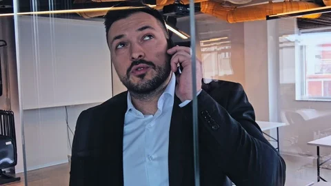 Manager talking seriously on the phone Stock Footage 94837241