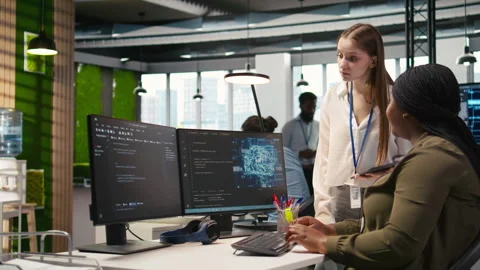 Manager teaching young technician how to develop software using AI Stock Footage 313018127