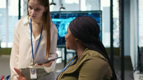 Manager teaching young technician how to develop software using AI Stock Footage 313167936