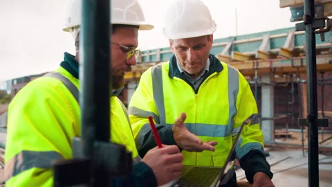 Manager, team and talk on construction site with laptop, advice and Stock Footage 336202086
