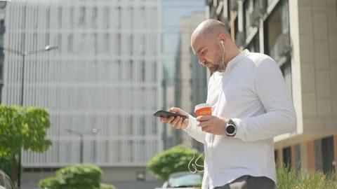 The manager is texting on the phone and drinking coffee Stock Footage 208913701
