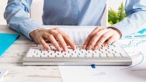 Manager typing on computer keyboard Manager typing on computer keyboard. C... Stock Photos