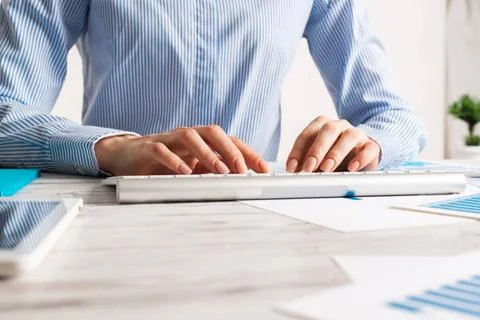 Manager typing on computer keyboard Manager typing on computer keyboard at... Stock Photos