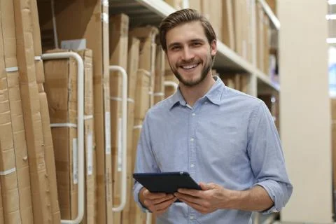 Manager use his tablet for online checking products available. Stock Photos
