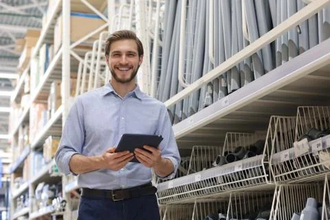 Manager use his tablet for online checking products available. Stock Photos