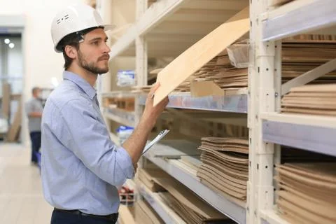 Manager use his tablet for online checking products available. Stock Photos