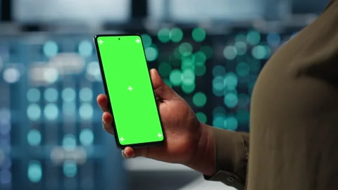 Manager using app on chroma key phone to check server farm energy consumption Stock Footage 317202842