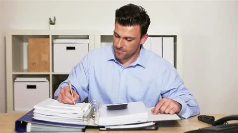 Manager using calculator in office Stock Footage 11019377