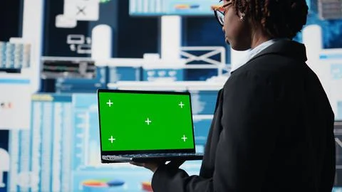 Manager using green screen laptop to compare company metrics Foto stock